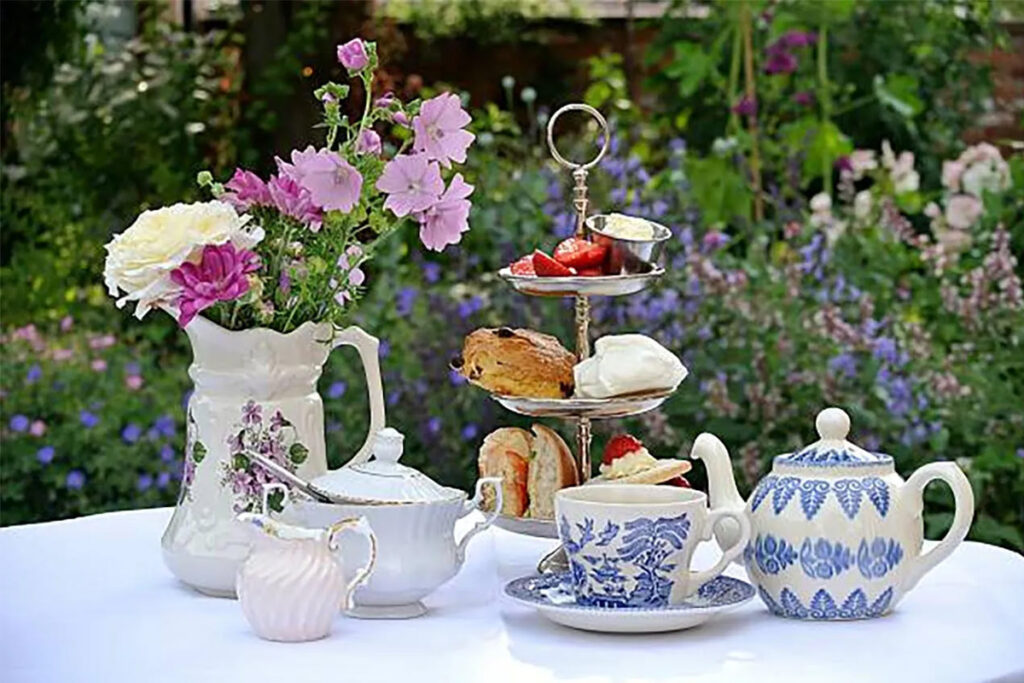 Garden tea setup with flowers and snacks