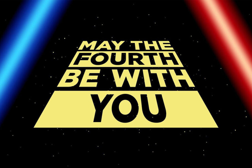 May the Fourth Be With You text in classic Star Wars style with red and blue lightsabers on a starry background
